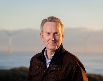 David Clark with turbines in background