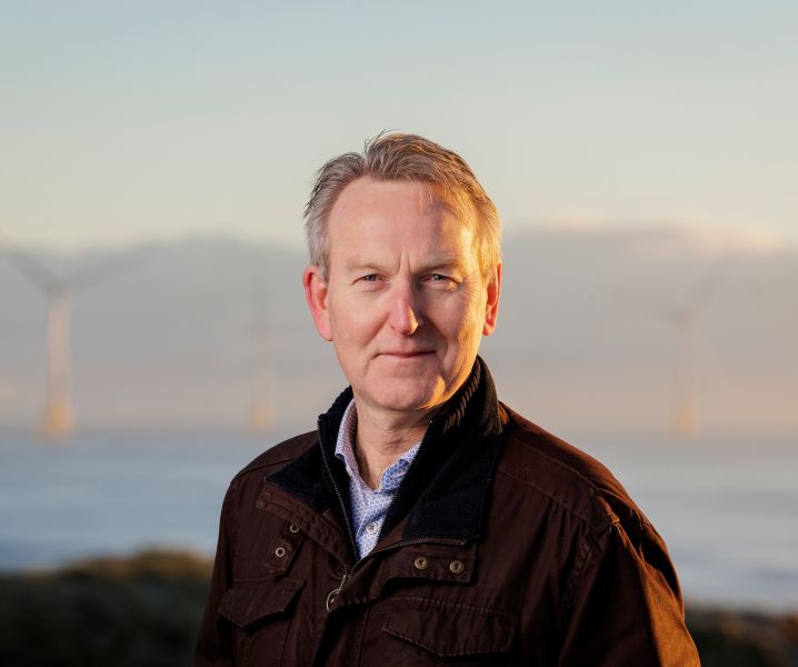 David Clark with turbines in background