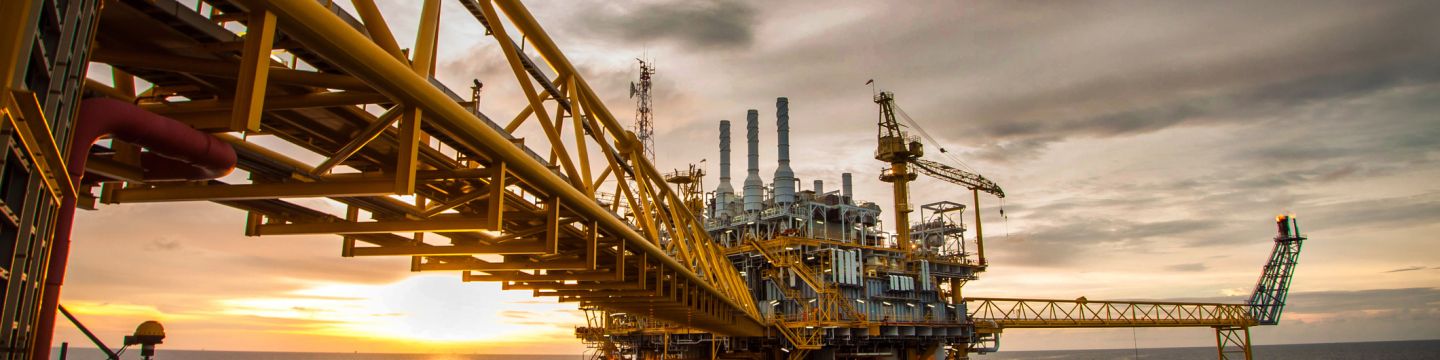 Getty Images 179565748 Oil and gas platform during sunrise or sunset