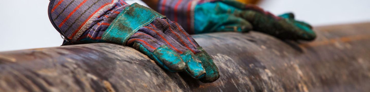 Gloves on a rusty pipe